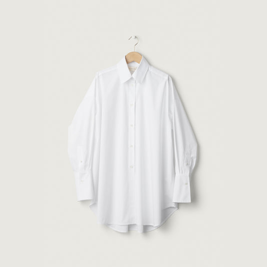 White shirt on a hanger against a light gray background